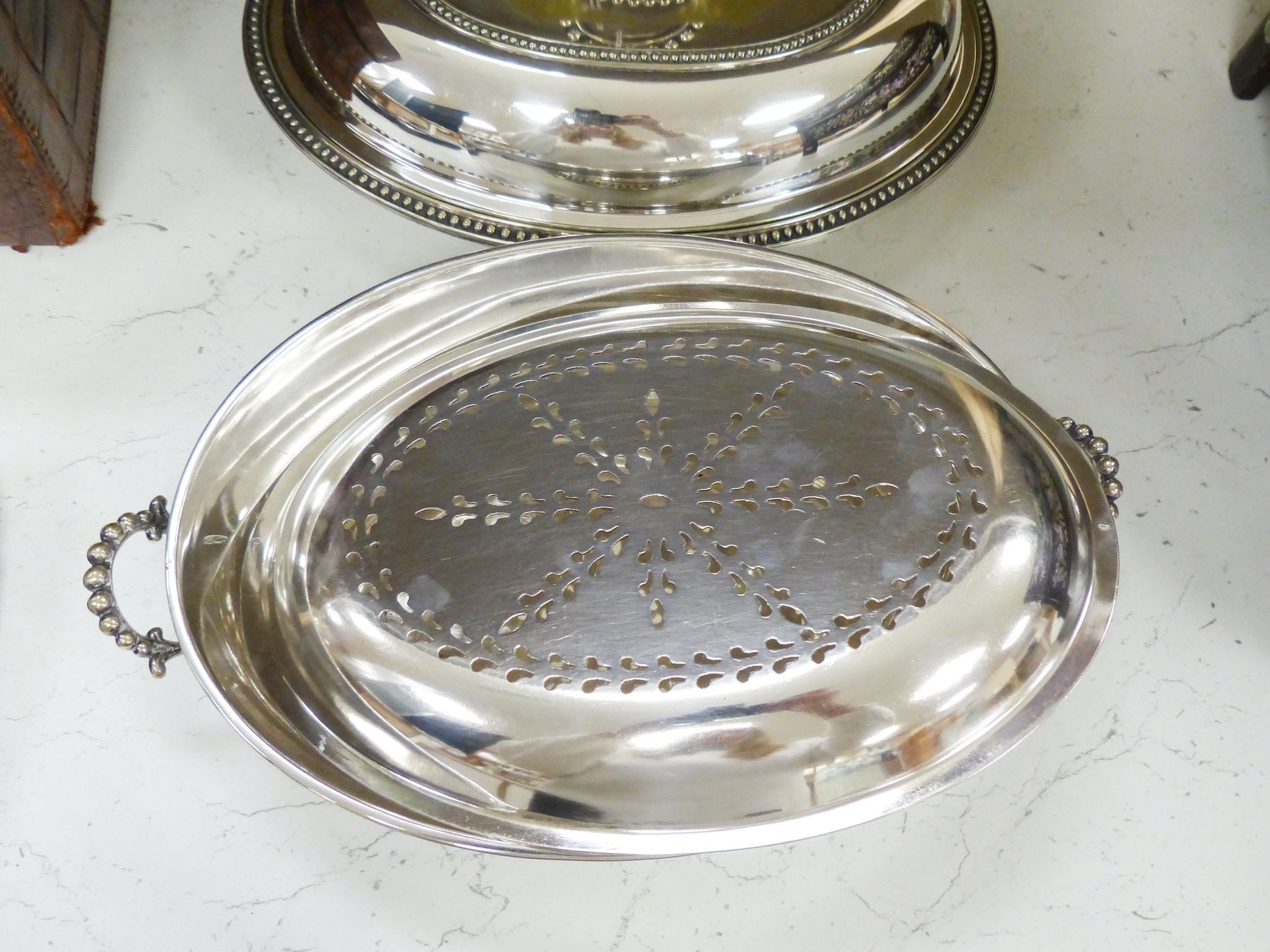 A pair of plated entrée dishes and covers and a similar entrée dish and cover